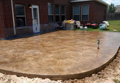 This image shows a patio with stained concrete.