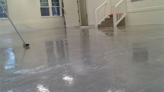 This image shows a garage floor that is being coated.