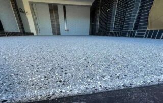This image shows a garage with flake epoxy floor.